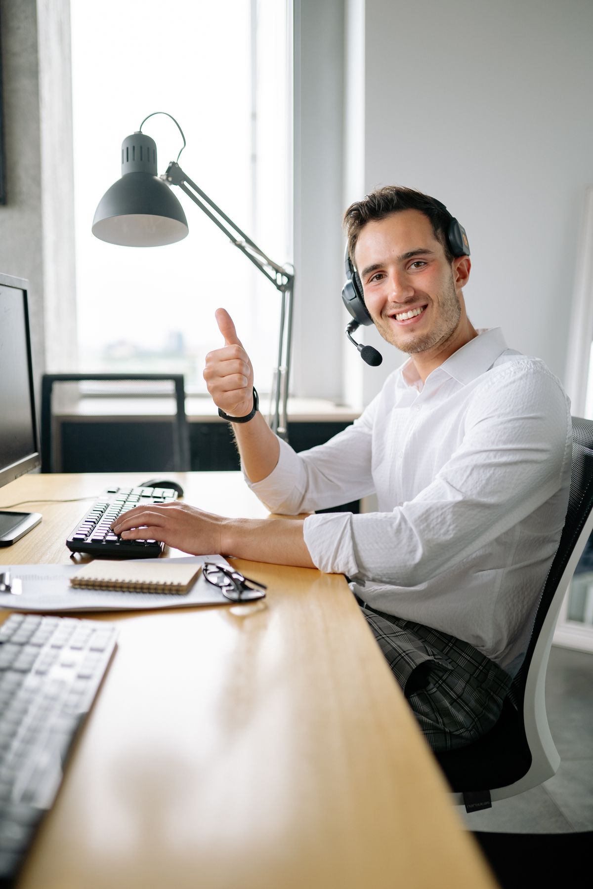 Customer support specialist giving positive feedback with a thumbs up