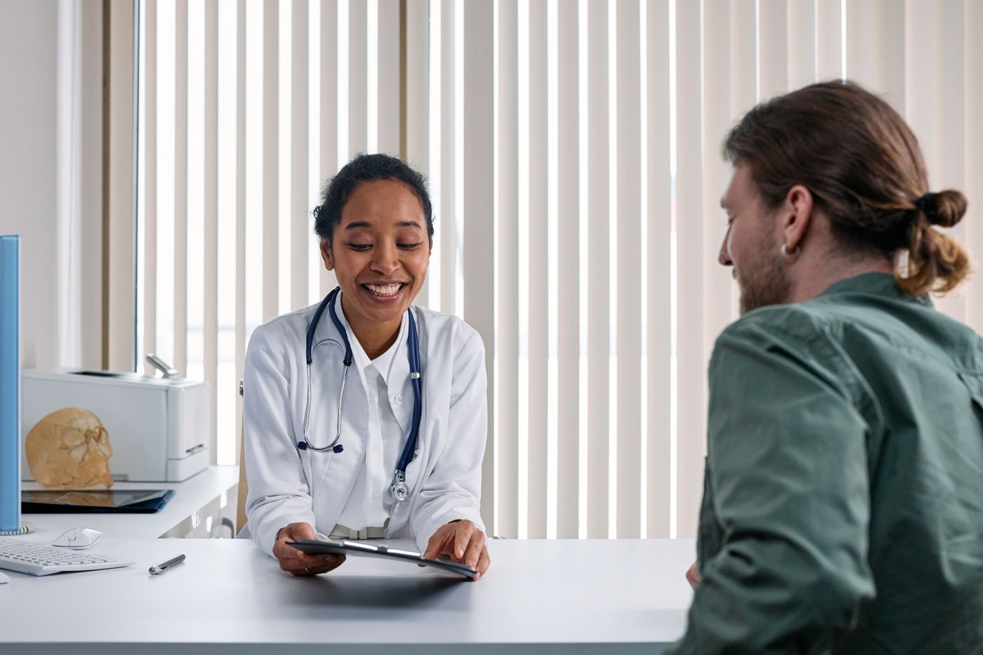 Healthcare receptionist assisting a patient